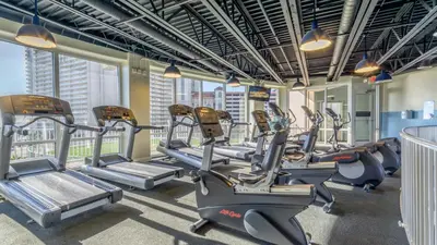 a gym with cardio equipment in a building at The Lost Flip Flop at Laketown Wharf #2012 by Nautical Properties in Panama City Beach