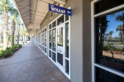 a walkway outside of a building with a sign on it at Some Beach Some Where at Laketown Wharf #825 by Nautical Properties in Panama City Beach