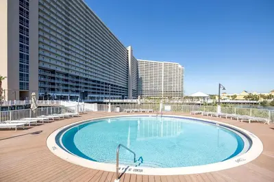 a large swimming pool with chairs and a building at The Beach Is Calling at Laketown Wharf #1329 at Nautical Properties in Panama City Beach