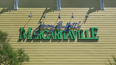 a neon sign on the side of a building at A Salty Cru in Panama City Beach