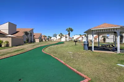 a green golf course with a gazebo at Walk to Beach! PCB Resort Condo with Pool Access in Panama City Beach