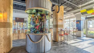 a large wooden exhibit in a room with tables and chairs at Laketown Wharf #1628 by Nautical Properties in Panama City Beach