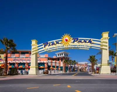 a large sign for a resort with a sun sign at Stylish 3BR 2BA House Minutes from PCB - Book now in Panama City