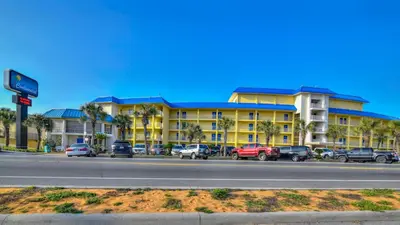 a large yellow building with cars parked in front of it at Continental 107 in Panama City Beach