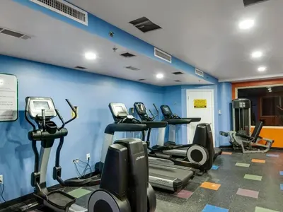 a gym with a bunch of tread machines in a room at Shores of Panama 2327 - 1 BedroomBunks and Sleeper Sofa, Sunset View! Free Fun! condo in Panama City Beach