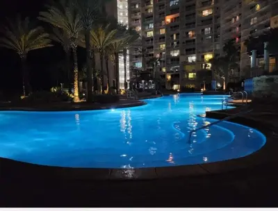 a large pool with blue water at night at Shores of Panama 314 - 1 BdBunks, Sleeps 6, Same Level Parking, Free Fun! condo in Panama City Beach