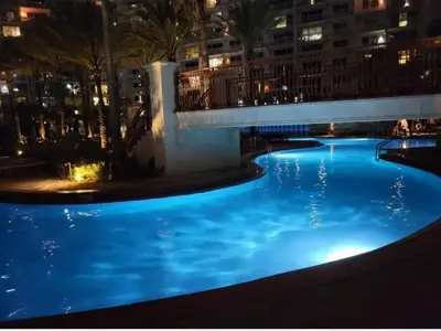 a large swimming pool at night with blue lights at Shores of Panama 2330 - 1 Bedroom Bunk Area Sleeps 6, Beautiful Direct Beach View! Free Fun! condo in Panama City Beach