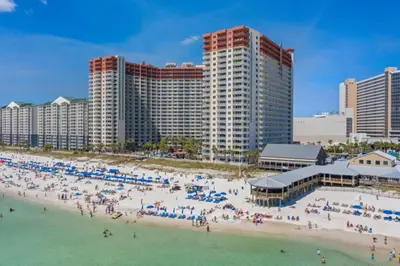 a group of people on a beach in front of buildings at Shores of Panama 1804 - 2 Bedroom Bunkroom Sleeps 8, Updated! Free Fun, condo in Panama City Beach