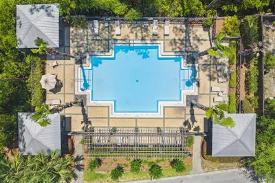 an overhead view of a swimming pool in a resort at 30A Beach House - Wonderland at Treetop by Panhandle Getaways in Rosemary Beach