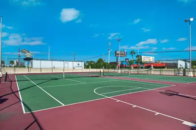 a tennis court with a net on top of it at Beachfront - Beach Chairs Included! - FLPCB53 in Panama City Beach