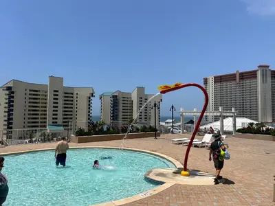 a group of people playing in a swimming pool at Remodeled 3BD plus Bunks! Low Floor Family Beach Resort! 5 Pools! by Dolce Vita Getaways PCB in Panama City Beach