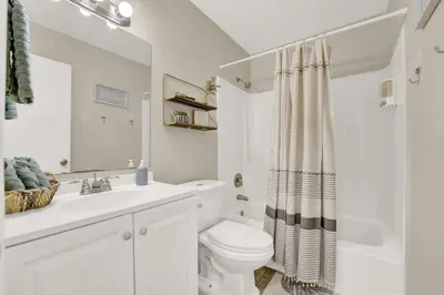 a white bathroom with a toilet and a sink at Modern Getaway North of Panama City Beach in Panama City