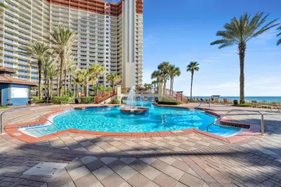 a swimming pool with a fountain in front of a building at Shores of Panama 2122 in Panama City Beach
