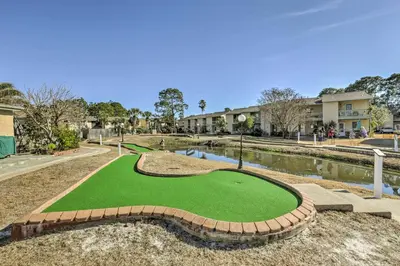 a miniature golf course with a pond and buildings at PCB Townhome with Resort Amenities - Walk to Ocean! in Panama City Beach
