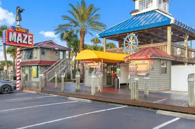 a building with a restaurant and a sign in a parking lot at Coral Cabana - 3BD 2BA Home Close to Beach w/ optional Golf Cart! in Panama City Beach
