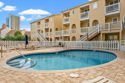 a swimming pool in front of a apartment building at Merrimac Resort #12 in Panama City Beach