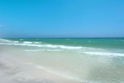 a sandy beach with the ocean in the background at Calypso 3-2210 - Love Nest in Panama City Beach