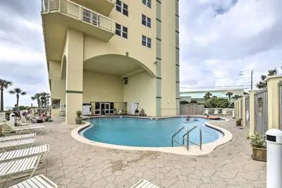 a swimming pool in front of a building at Balcony and Beach Access Oceanfront PCB Condo in Panama City Beach