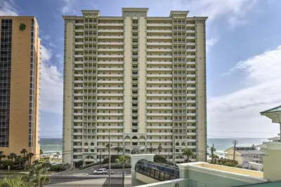 a large building with the ocean in the background at Balcony and Beach Access Oceanfront PCB Condo in Panama City Beach