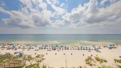 a beach with a lot of umbrellas and the ocean at Beachfront Condo #608 at Majestic Beach Resort in Panama City Beach