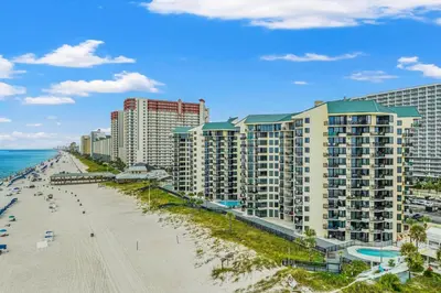 an aerial view of a beach and buildings at Sunbird Resort! Incredible Beachfront Corner Unit! Free Beach Chairs! by Dolce Vita Getaways PCB in Panama City Beach