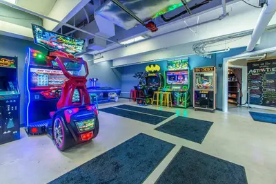 a room with arcade games and a video game console at Emerald Beach 930 in Panama City Beach