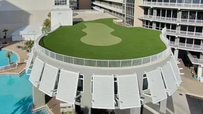 an aerial view of a building with a golf course on the lawn at Laketown Wharf #1404 by Nautical Properties in Panama City Beach
