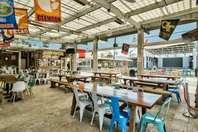 an empty restaurant with wooden tables and chairs at Prominence on 30A Homes by Panhandle Getaways in Watersound Beach