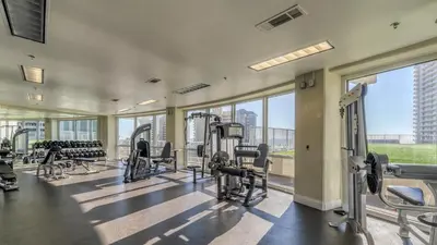 a gym with treadmills and cardio equipment in a building at Laketown Wharf #311 by Nautical Properties in Panama City Beach