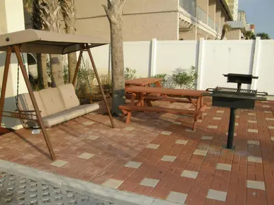 a swing and a bench on a patio at Grandview East #403 in Panama City Beach