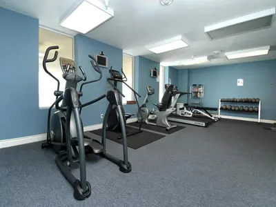 a gym with treadmills and ellipticals in a room at Grandview East #403 in Panama City Beach
