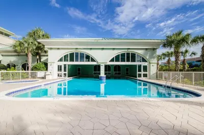 a swimming pool in front of a house at Celadon 302 in Panama City Beach