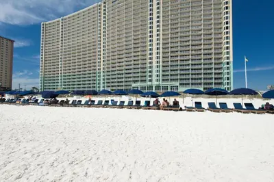 a building with blue and white umbrellas on the beach at Emerald Beach Resort 2235 in Panama City Beach
