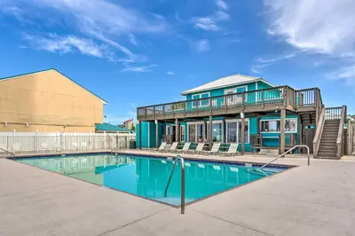 a house with a swimming pool in front of a house at Walk to Beach and Restaurants PCB Resort Condo! in Panama City Beach