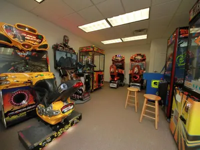 a room with many arcade games and other games at Tidewater Beach Resort #1306 - Beach Bliss in Panama City Beach