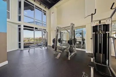 a gym with two tread machines in a room at Laketown Wharf #1014 in Panama City Beach