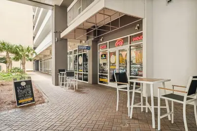 a restaurant with tables and chairs in a building at Laketown Wharf #2025 in Panama City Beach