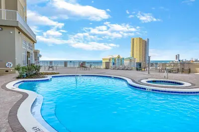 a swimming pool with a view of the ocean at Grand Panama #1-1207 in Panama City Beach