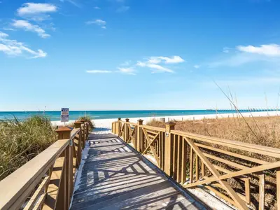 a wooden walkway to the beach with the ocean at Grand Panama Beach Resort - The Grand #704 in Panama City Beach