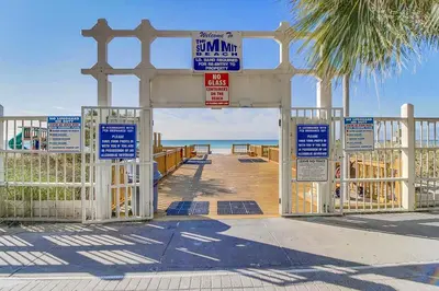 a gate at the beach with signs on it at The Summit 1426 in Panama City Beach