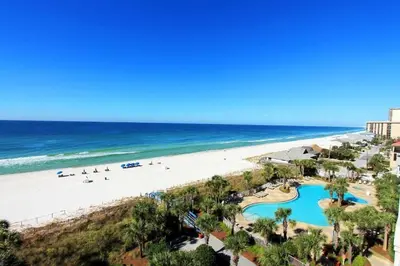 a view of the beach from the balcony of a resort at Sterling Beach #1206 in Panama City Beach