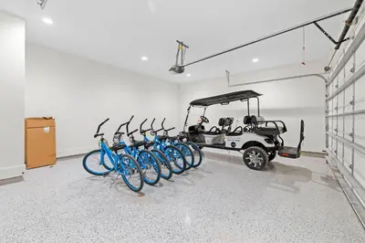 a group of bikes parked in a room with a golf cart at Seven Palms Retreat in Inlet Beach
