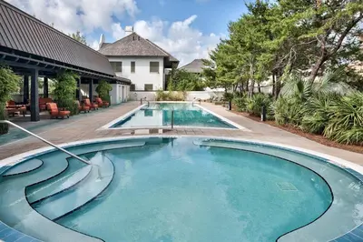 a swimming pool in front of a house at Mercado at Rosemary 4A in Rosemary Beach