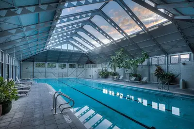 a large swimming pool with a large glass ceiling at 34 S Briland Lane Carriage House in Rosemary Beach