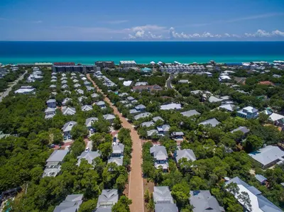 an aerial view of a resort complex next to the ocean at 30A Magnolia Cottages by the Sea by Panhandle Getaways in Seacrest