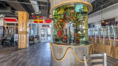 a large glass vase on a stand in a room at Laketown Wharf #1734 by Nautical Properties in Panama City Beach