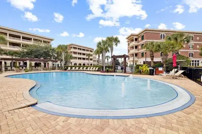 a large swimming pool in a courtyard with buildings at 275 Lifeguard Loop by 30A Escapes in Rosemary Beach