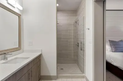 a bathroom with a walk in shower next to a sink at The Pointe Unit 111 by 30A Escapes in Rosemary Beach
