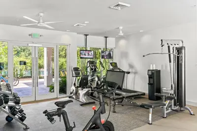 a gym with treadmills and exercise bikes in a room at The Pointe Unit 121 by 30A Escapes in Rosemary Beach