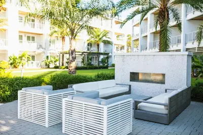 a patio with a fireplace in front of a building at The Pointe Unit 326 by 30A Escapes in Rosemary Beach